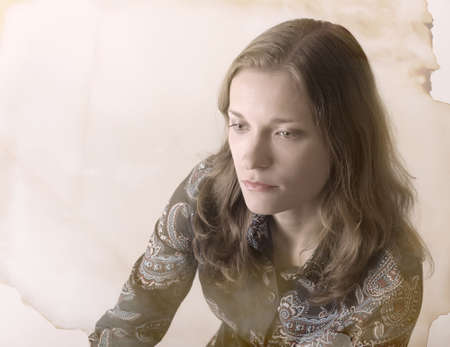 Beautiful sad woman over abstract vintage background