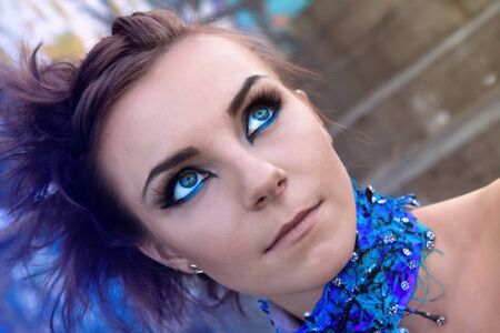 Face of a beautiful cyber futuristic woman with blue make upの写真素材