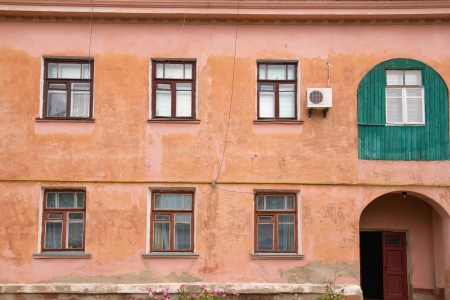 Building Facade  windows and old wall with arch doorの写真素材