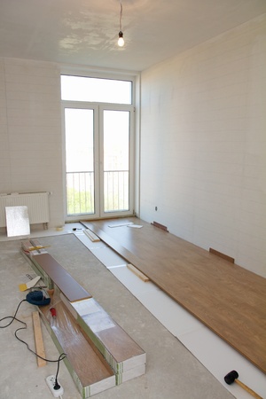 Empty room with laminate flooring and toolsの写真素材