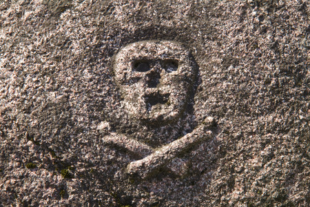 Carved skull with crossbones on the Tombstone 