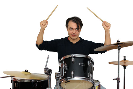 drummer playing the drums isolated on a white backgroundの写真素材