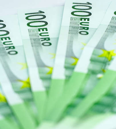 Close-up of 100 Euro bills isolated on a white backgroundの写真素材