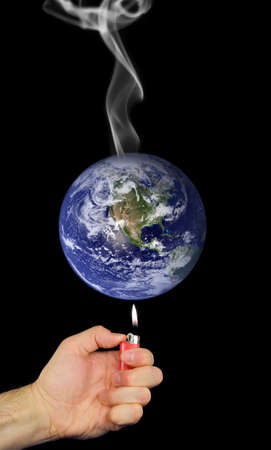 Photo montage representing global warming with lighter held to earth and smoke rising.  Earth photo courtesy of NASA visibleearth.nasa.govの写真素材
