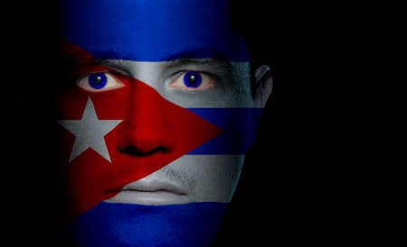 Cuban flag painted/projected onto a man's face.の写真素材