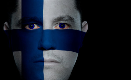 Finnish flag painted/projected onto a man's face.の写真素材