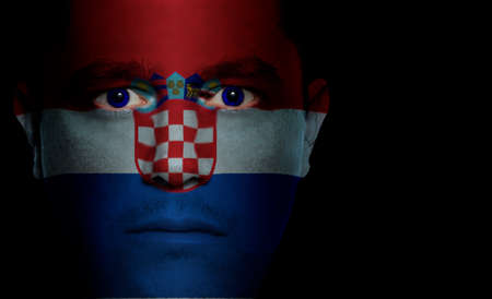 Croatian flag painted/projected onto a man's face.の写真素材