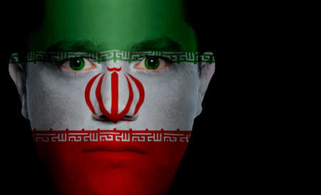 Iranian flag painted/projected onto a man's face.の写真素材