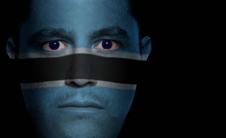 Botswanan flag painted/projected onto a man's faceの写真素材