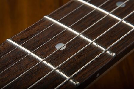 Closeup of six string guitar fret board