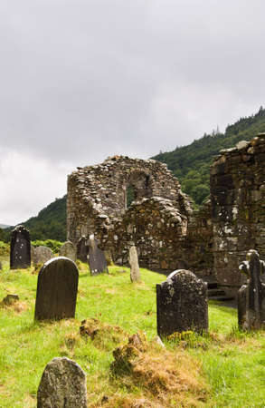 Cathedral ruins at Glendalough (Gleann Da Loch)  National Heritage Center in Ireland. View over the ancient cemetery and Wicklow mountains. の写真素材