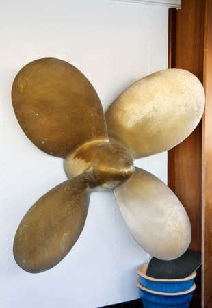 The propeller of a ship, displayed on a boat. 