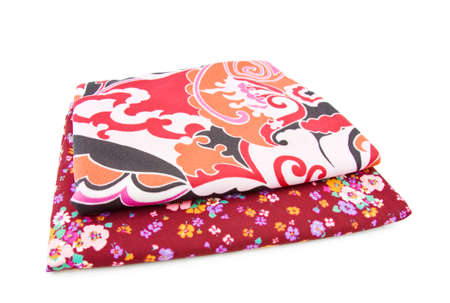 Retro polyester textiles with floral patterns in red. Isolated over white background. 