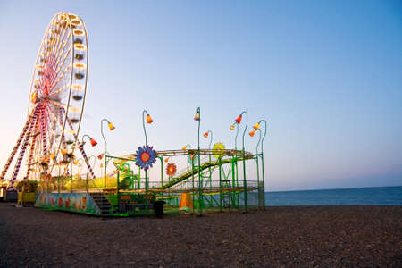 Vacation fun - amusement park on the beach near the ocean with ferris wheel and roller coaster. Shot taken in Bray, county Wicklow, Irelandのeditorial素材