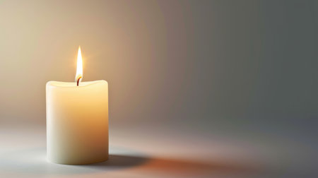 White candle on white background with a free place for text. Concept of home, spa, relaxation, meditation or festive celebration bannerの素材