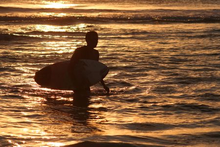 Surfer at sunset, Kuta beachの写真素材