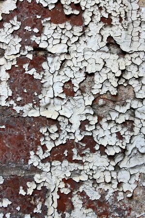 Old paint peeling from brick wall textureの写真素材