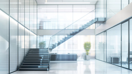 Modern office interior with glass walls and escalators.の素材