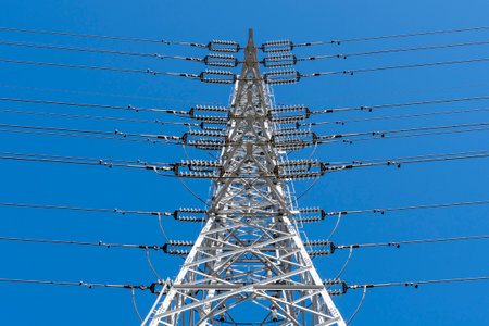 Power transmission towers towering against the blue sky