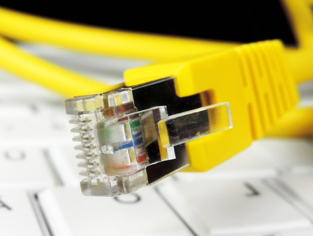 yellow cable and white laptop.