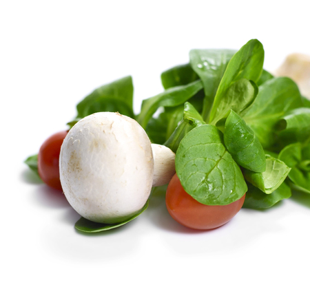 Fresh garden salad, isolated on white background. Corn salad with cherry tomatoes and white mushrooms.の写真素材