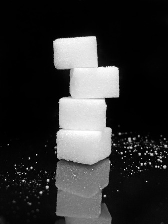 Sugar cubes on black background. Low key close-up. Stack rock.の写真素材