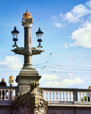 Amsterdam, NetherlanCanal of Amsterdam with an old bridge. Decorative bridge with old street lights in Amsterdam, the Netherlands.のeditorial素材