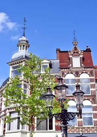 Old town houses in a historic city of the Netherlands. View to an old, decorative lantern and beautiful historic house facades of the turn of the century.のeditorial素材