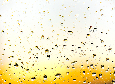 selective focus of raindrops on a window. Sunset or sunrise.の写真素材