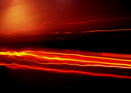 Waves of red and yellow light on black background. Design background or abstract background with copy space.の写真素材