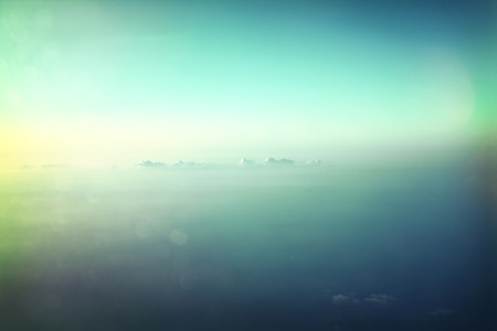 Sky background with clouds and copy space. Sunset scene, view outside of an airplane window. Lens...