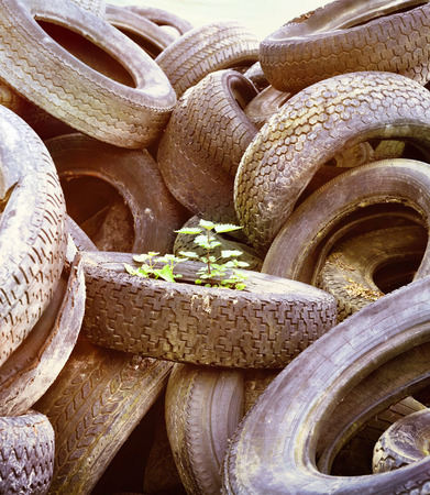 Stack of old car tires or wheels. Full frame shot of old, weathered tires. Monochrome toned image.の写真素材