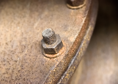 Rusty screw, machine part of an old factoryの写真素材