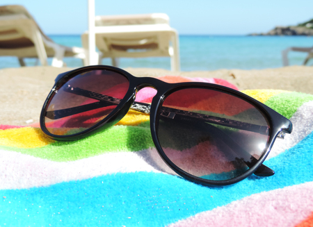 Sunglasses and book on the beachの写真素材