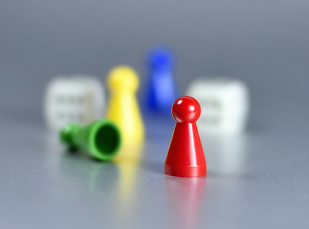 Playing pieces and dice, isolated gray background