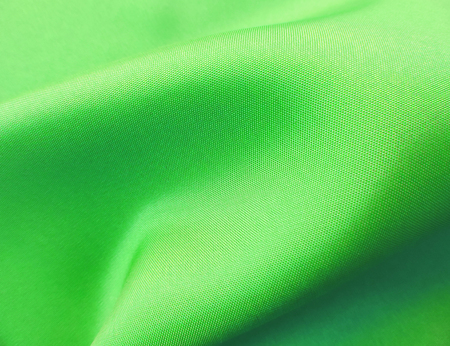Green cloth or textile, wavy textile, close-up shot.の写真素材