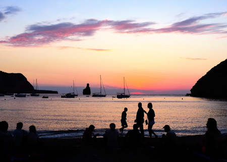 People watching the sunset at Benirras Beachの写真素材