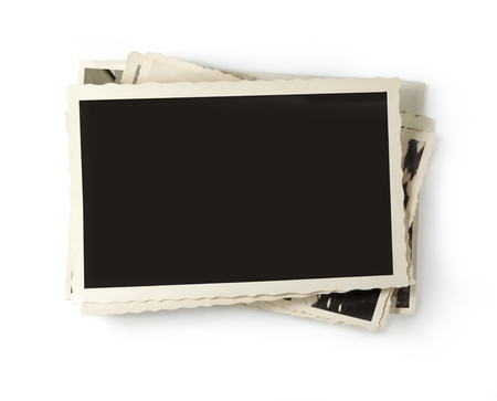 Stack of old, vintage photos with copy space, isolated on white background.の写真素材