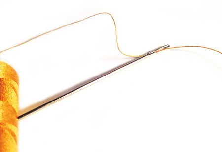 Sewing material with bobbin and needle, isolated on white backround with copy space.の写真素材