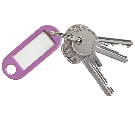 Key ring with silver keys and blank name tag with copy space, isolated on white background.の写真素材