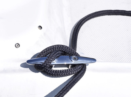 Anchored motorboat, close-up of rope, fixed on a yacht.