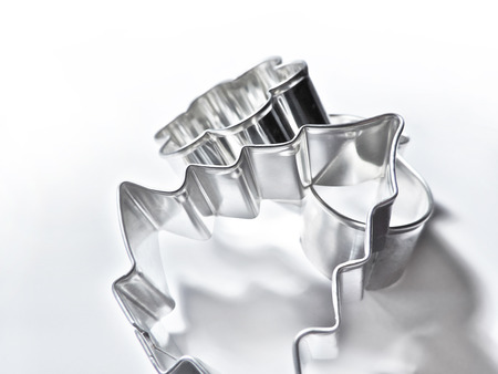 Christmas cookie cutters, silver metal cutters, studio shot.