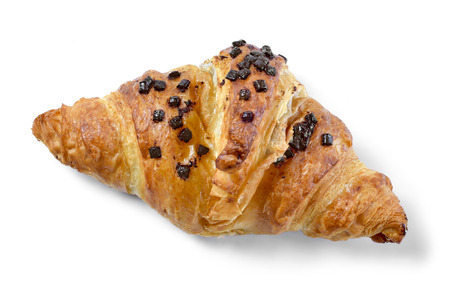 Delicious french chocolate croissant or butter croissant with chocolate filling and chocolate crumbles. Fresh croissant, top view, isolated on white background.の写真素材
