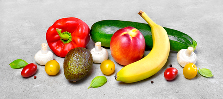 Delicious fresh fruits and vegetables on a stone background. Top view with copy space.の写真素材
