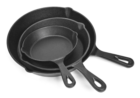Cast iron pans with empty space, isolated on white background. Cut out objects with high angle view and copy space.の写真素材