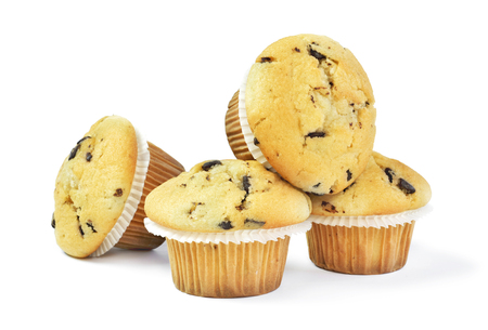 Delicious vanilla muffins with chocolate, isolated on white background. Muffins with paper, sweet food or unhealthy eating theme.の写真素材
