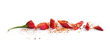 Red chilli pepper, cut into pieces and isolated on white background. Hot spice, red pepper and...