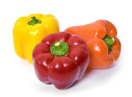 Fresh bell peppers isolated on white background. Red, orange and yellow bell peppers, cooking ingredients, healthy lifestyle.の写真素材