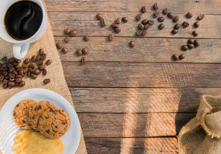 coffee cup wooden background with coffee beans.の写真素材