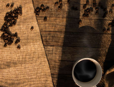 coffee cup wooden background with coffee beans.の写真素材